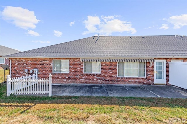 119 Ohio Ct, Farmington, MO 63640 - back of house with roof with shingles, brick siding, and a patio area