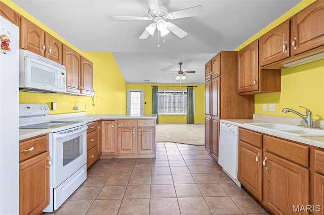 119 Ohio Ct, Farmington, MO 63640 - kitchen with white appliances, a sink, light countertops, and a peninsula