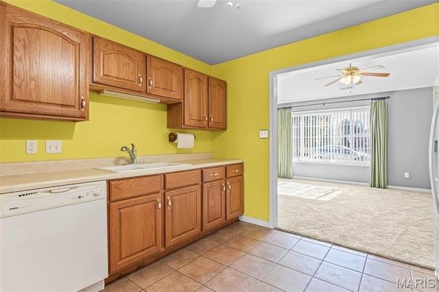 119 Ohio Ct, Farmington, MO 63640 - kitchen with dishwasher, a sink, a ceiling fan, light colored carpet, and light countertops