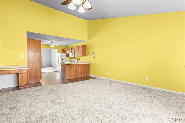 119 Ohio Ct, Farmington, MO 63640 - unfurnished living room featuring a ceiling fan, dark colored carpet, baseboards, and dark tile patterned floors