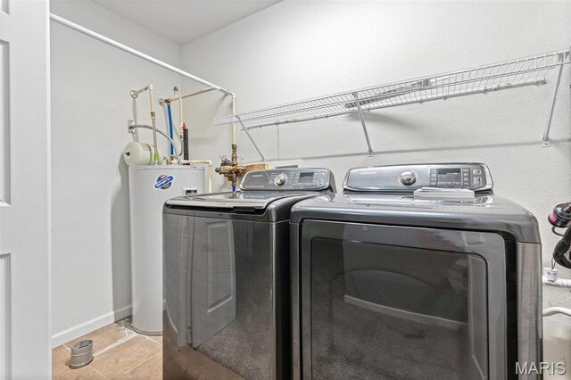 119 Ohio Ct, Farmington, MO 63640 - laundry room with water heater, washer and clothes dryer, baseboards, and tile patterned flooring