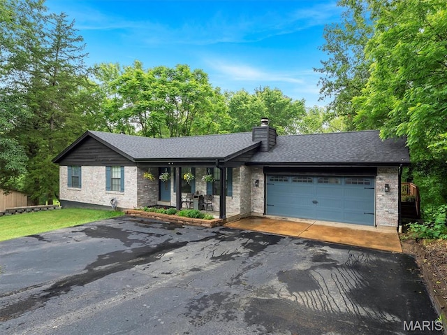 575 E Villa Ridge Rd, Villa Ridge, MO 63089 - view of front of home featuring asphalt driveway, a garage, brick siding, and a chimney