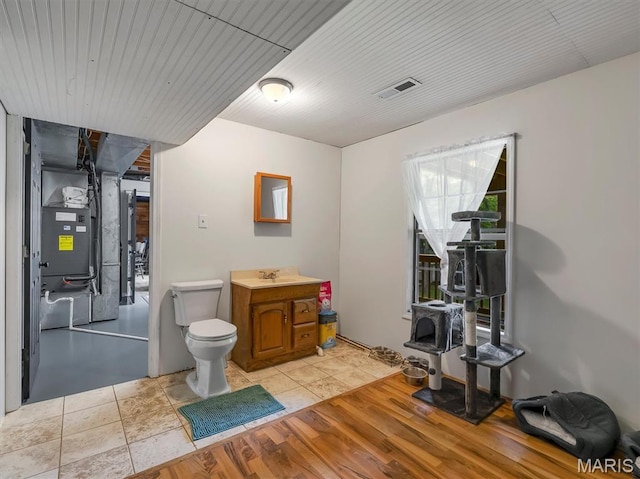 575 E Villa Ridge Rd, Villa Ridge, MO 63089 - bathroom with vanity, heating unit, and wood finished floors