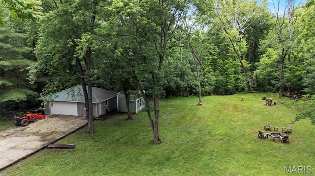 575 E Villa Ridge Rd, Villa Ridge, MO 63089 - view of green lawn featuring driveway, an outdoor structure, and an outdoor fire pit