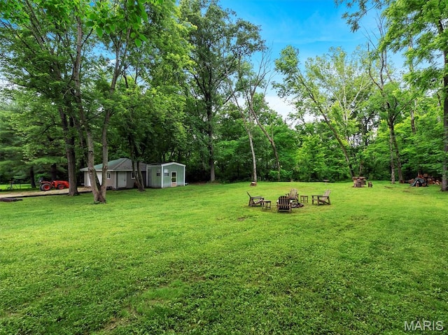 575 E Villa Ridge Rd, Villa Ridge, MO 63089 - view of green lawn featuring an outdoor fire pit and an outbuilding