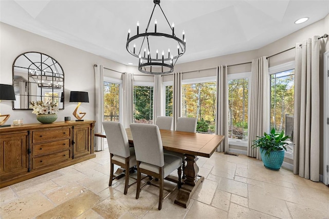 dining space with stone tile floors, a chandelier, recessed lighting, and healthy amount of natural light