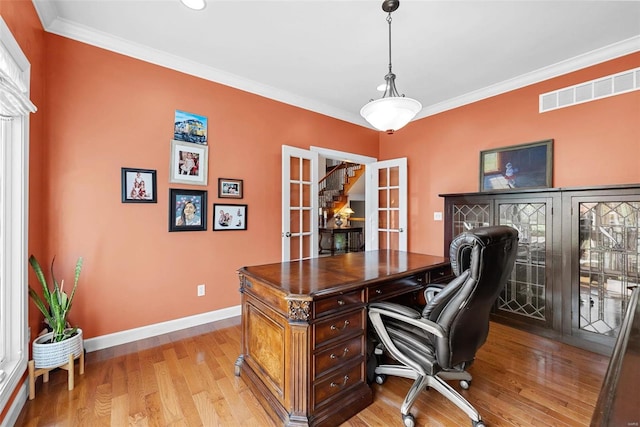 office featuring french doors, light wood-type flooring, baseboards, and crown molding
