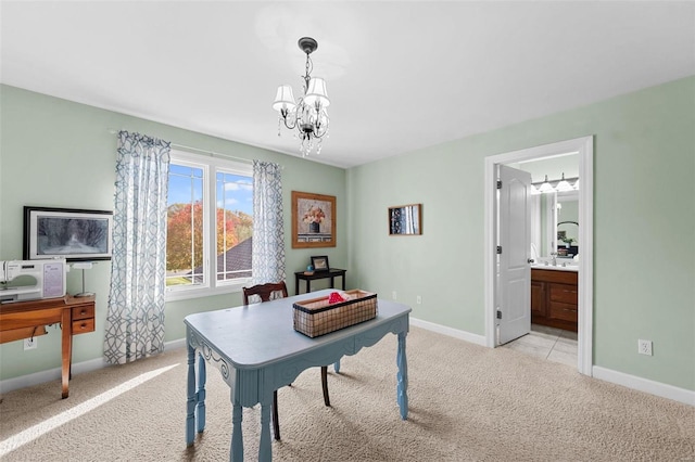 office area with light colored carpet, a chandelier, and baseboards