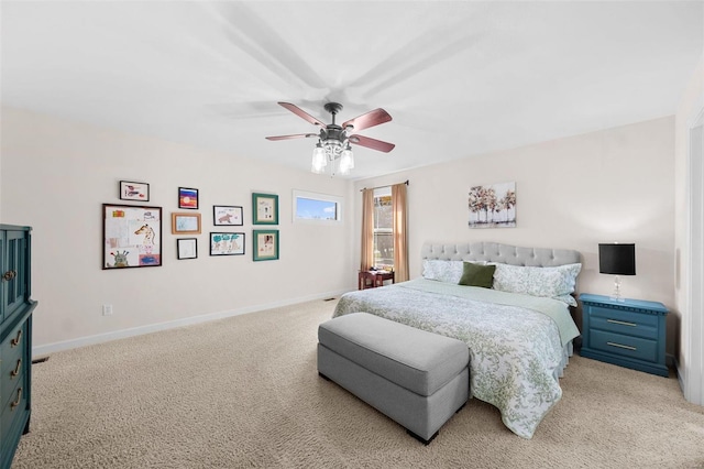 bedroom featuring light carpet, a ceiling fan, and baseboards