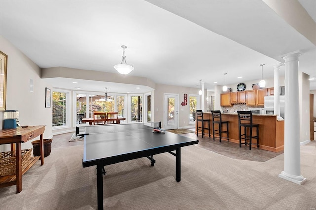 rec room featuring light carpet, baseboards, recessed lighting, and ornate columns