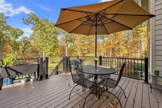 wooden deck featuring outdoor dining area