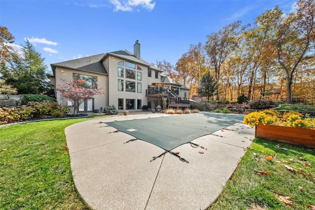 view of swimming pool with a patio area, a lawn, and a wooden deck