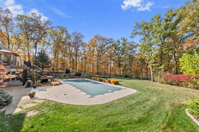view of pool featuring a patio, a lawn, a covered pool, and stairway