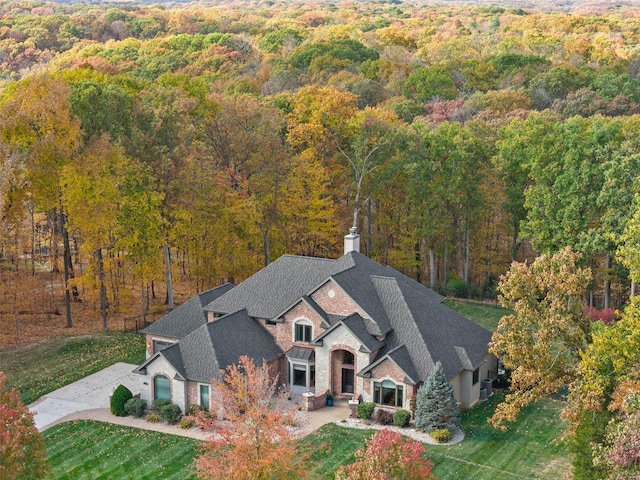 view of subject property featuring a heavily wooded area