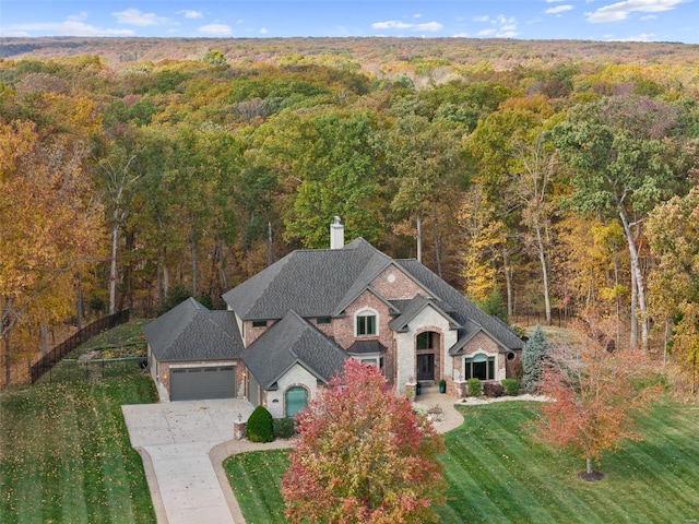 view of subject property featuring a heavily wooded area