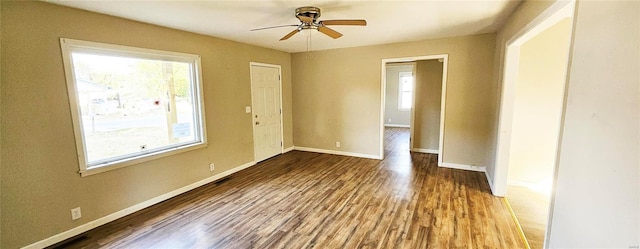 spare room with wood finished floors, baseboards, and ceiling fan
