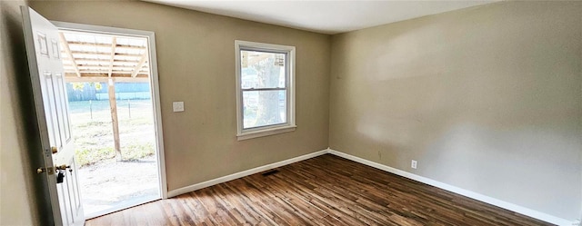 doorway to outside featuring baseboards and dark wood-style flooring
