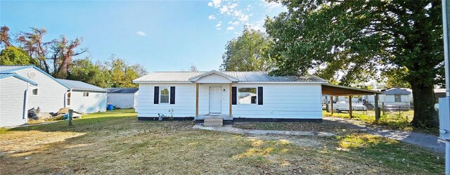 view of front of home with metal roof and a carport