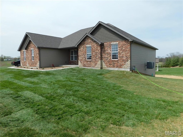 view of front of home with brick siding and a front lawn