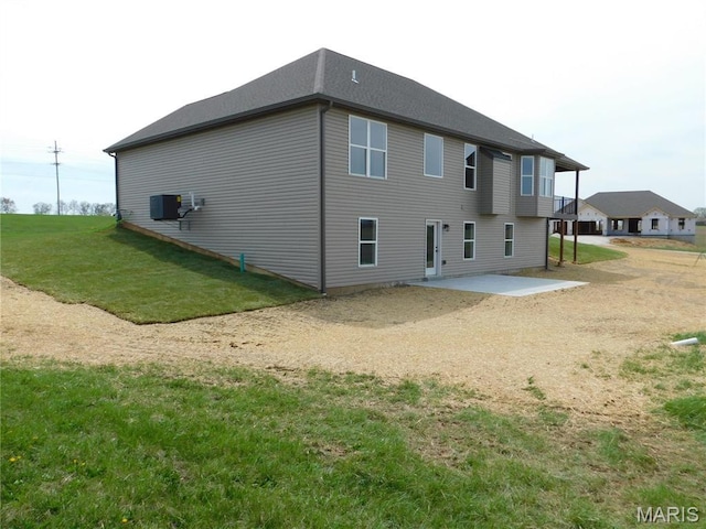 back of property with a patio area, central AC, and a yard