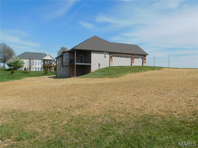 view of side of property featuring a yard and an attached garage