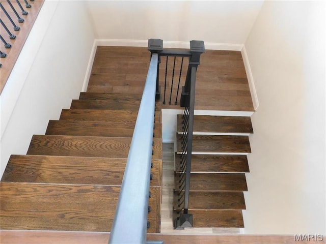 stairs with baseboards and wood finished floors
