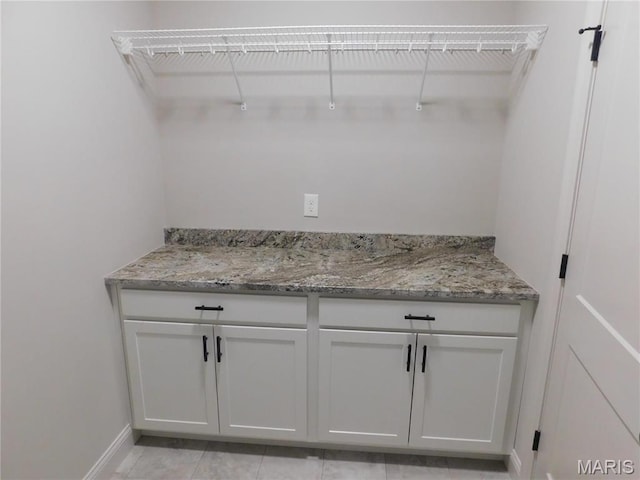 bar with baseboards and light tile patterned floors
