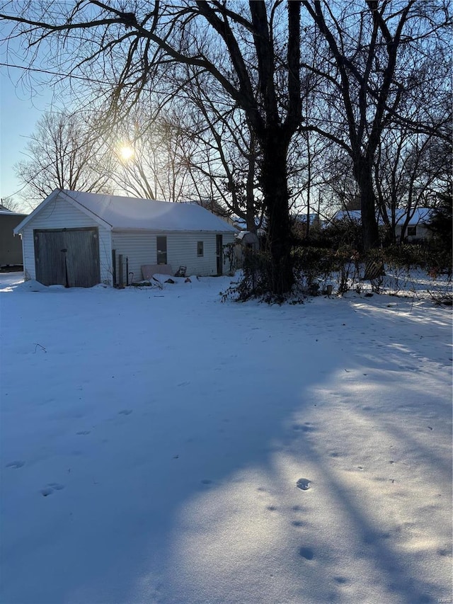 530 N Duncan St, Marine, IL 62061 - snowy yard featuring a garage and an outbuilding