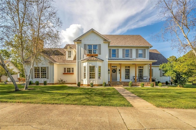 view of front of house with a porch, a shingled roof, a standing seam roof, and a front yard