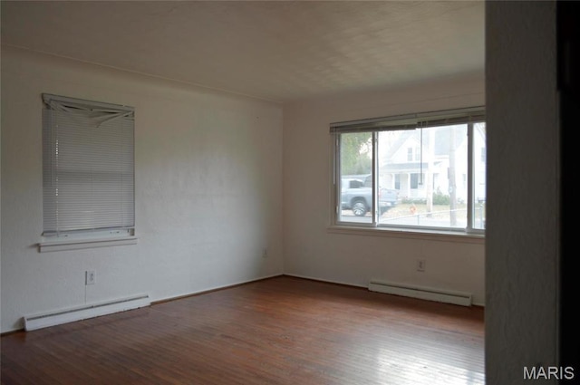 2108 Holland St, Alton, IL 62002 - empty room with a baseboard heating unit and wood finished floors