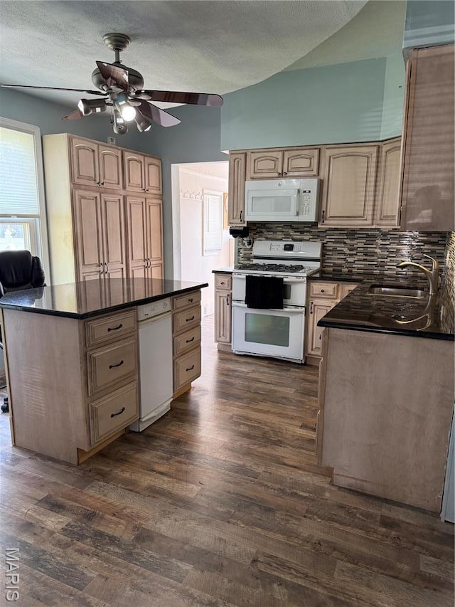 kitchen with white appliances, a sink, dark countertops, a ceiling fan, and backsplash