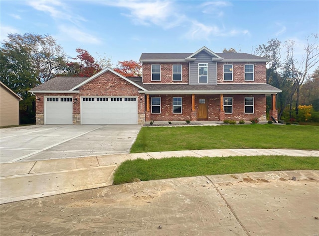 1232 Scuddler, Troy, IL 62294 - view of front of house with a garage, driveway, a front lawn, brick siding, and a porch