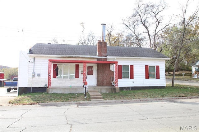 130 W Fite St, Park Hills, MO 63601 - view of front of home with covered porch, a chimney, and brick siding