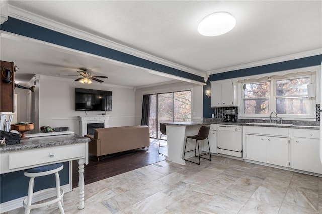 24950 State Rd A, Richland, MO 65556 - kitchen with dishwasher, crown molding, a sink, white cabinets, and a fireplace