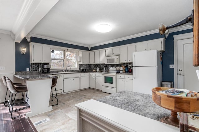 24950 State Rd A, Richland, MO 65556 - kitchen with white appliances, crown molding, decorative backsplash, a peninsula, and white cabinetry