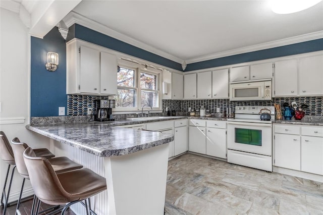 24950 State Rd A, Richland, MO 65556 - kitchen with white appliances, a sink, ornamental molding, decorative backsplash, and a peninsula