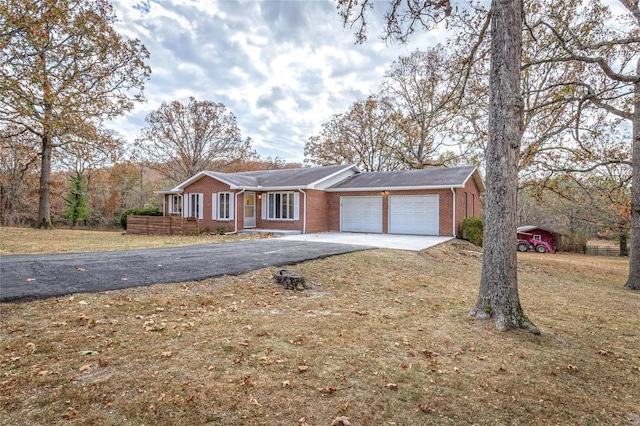 24950 State Rd A, Richland, MO 65556 - ranch-style home featuring asphalt driveway, an attached garage, brick siding, and a front yard