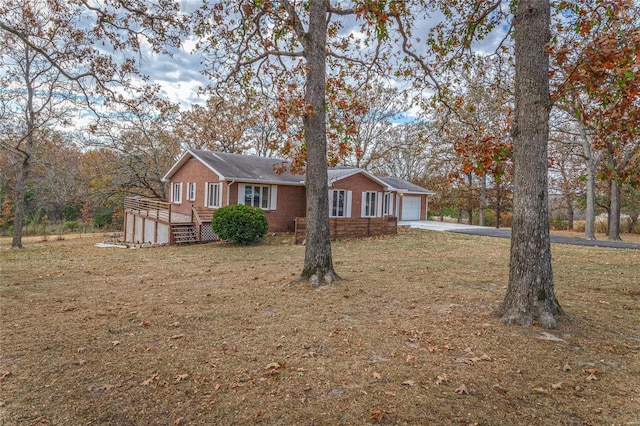 24950 State Rd A, Richland, MO 65556 - single story home with a front yard, brick siding, an attached garage, and driveway