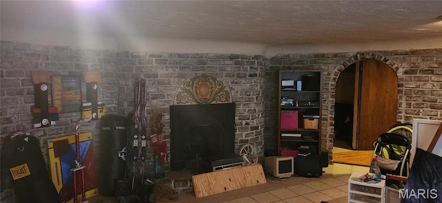 235 Quindaro Dr, Florissant, MO 63034 - tiled living room featuring a fireplace and arched walkways