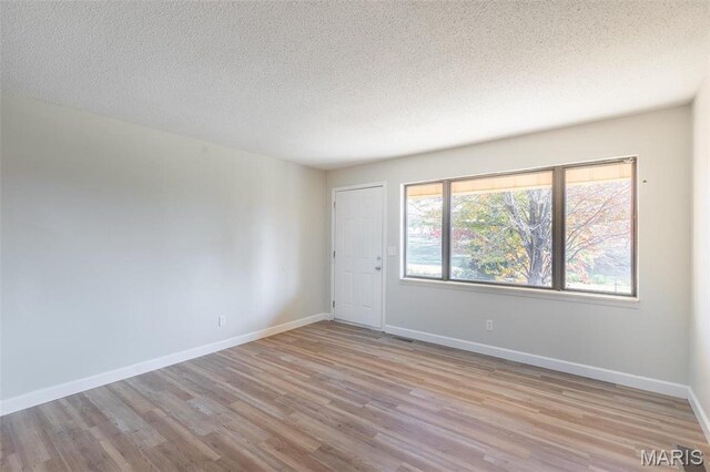 2637 Forest View St, Poplar Bluff, MO 63901 - spare room with wood finished floors, a textured ceiling, and baseboards