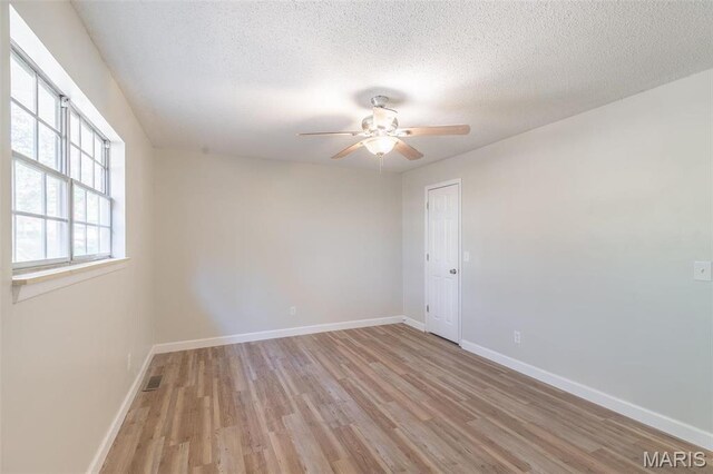 2637 Forest View St, Poplar Bluff, MO 63901 - empty room featuring light wood-type flooring, a ceiling fan, baseboards, and a textured ceiling