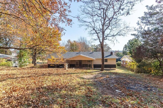 2637 Forest View St, Poplar Bluff, MO 63901 - back of property featuring a chimney, fence, and roof with shingles