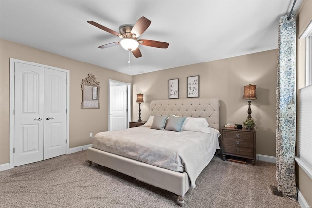 carpeted bedroom with baseboards, a closet, and a ceiling fan