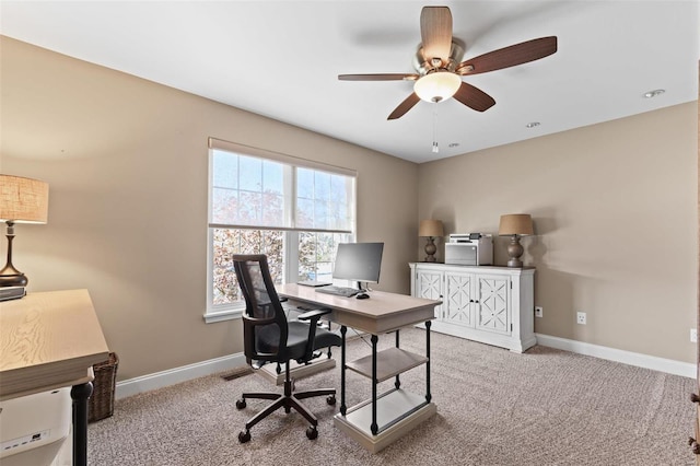 home office featuring ceiling fan, baseboards, and carpet flooring