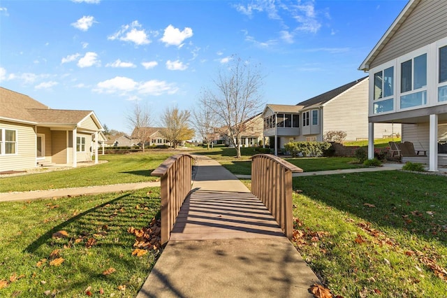 view of home's community featuring a residential view and a lawn