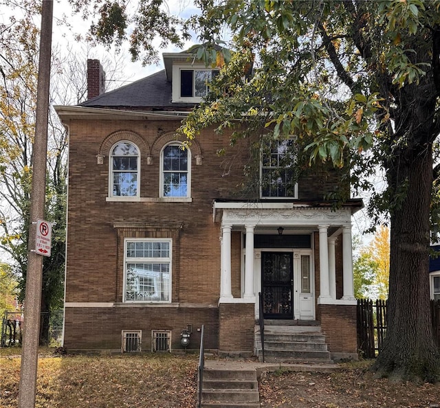 5168 Vernon Ave, Saint Louis, MO 63113 - view of front facade with a chimney, brick siding, and fence