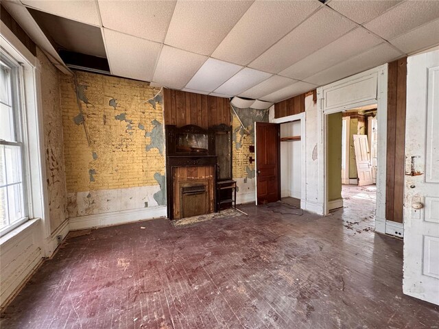 5168 Vernon Ave, Saint Louis, MO 63113 - unfurnished living room featuring a drop ceiling and a fireplace