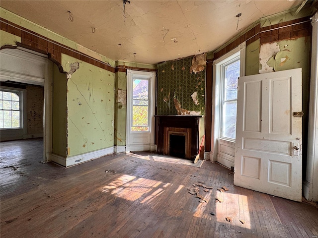 5168 Vernon Ave, Saint Louis, MO 63113 - unfurnished living room with hardwood / wood-style flooring, a fireplace, and plenty of natural light