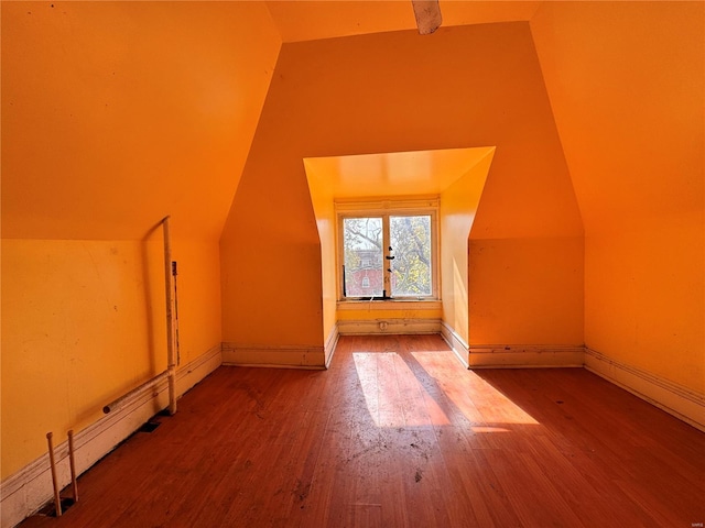 5168 Vernon Ave, Saint Louis, MO 63113 - additional living space with wood finished floors, vaulted ceiling, and baseboards