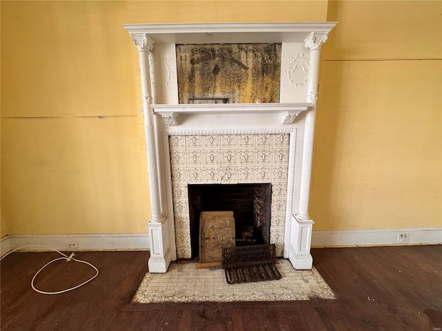 5168 Vernon Ave, Saint Louis, MO 63113 - detailed view of wood finished floors, a tiled fireplace, and baseboards